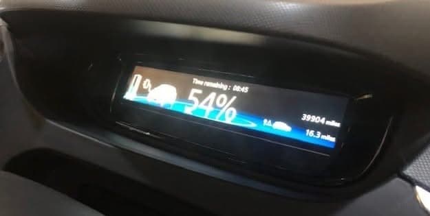 A charging cable connected to an electric vehicle at Ace Auto Centre
