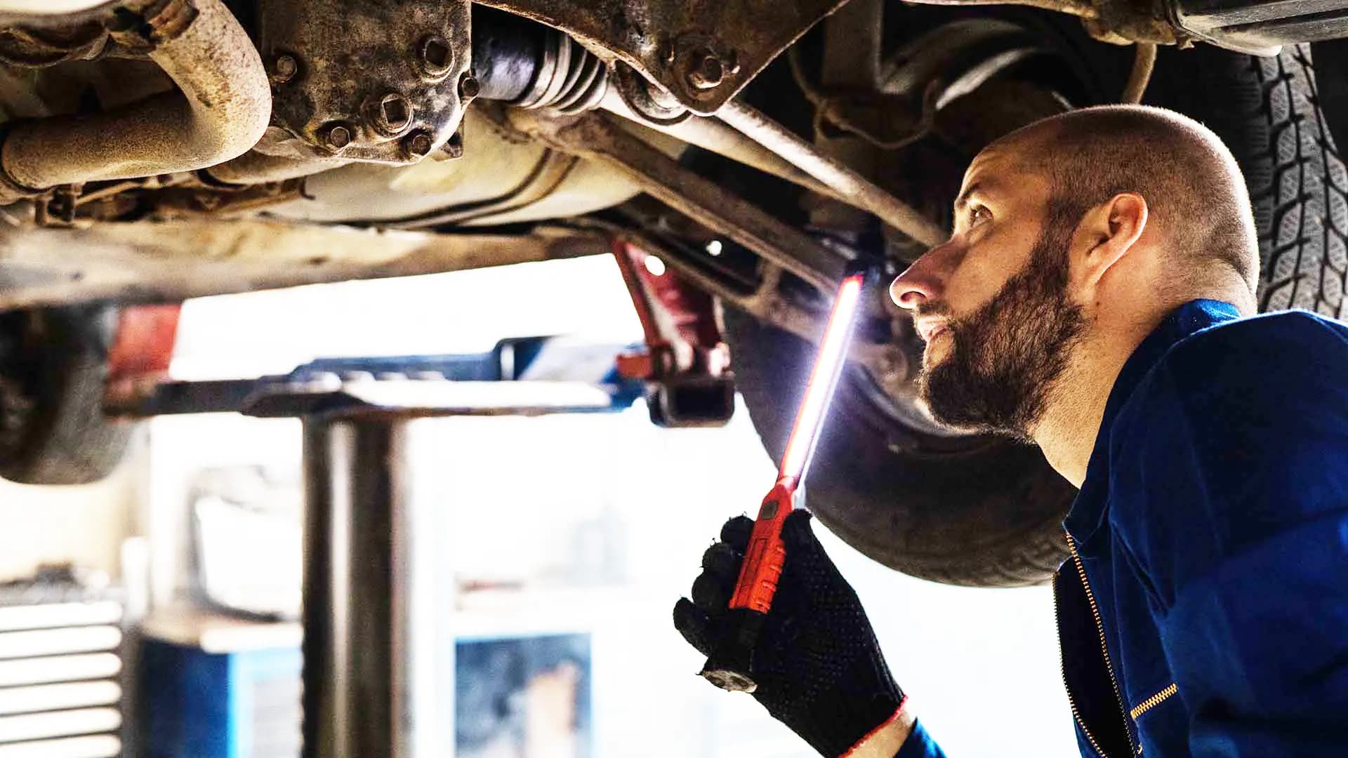 A mechanic working on a car in the Ace Auto Centre workshop